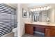 Bathroom with double sink vanity, large mirror, and tub shower with blue and white striped curtain at 9820 Queensway Blvd. # 804, Myrtle Beach, SC 29572