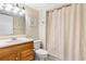 Bathroom features a single sink vanity, toilet, neutral shower curtain, and tiled flooring at 9820 Queensway Blvd. # 804, Myrtle Beach, SC 29572