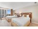 Bright bedroom featuring two beds, each adorned with fluffy white comforters, and a private balcony at 9820 Queensway Blvd. # 804, Myrtle Beach, SC 29572