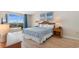 Bright bedroom featuring a queen bed, balcony access with ocean view, and beach-themed art pieces at 9820 Queensway Blvd. # 804, Myrtle Beach, SC 29572