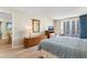 Bedroom with balcony access and ocean view, complete with a TV, dresser and a comfortable queen bed at 9820 Queensway Blvd. # 804, Myrtle Beach, SC 29572