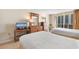 Comfortable bedroom featuring two beds, dresser, TV, and a private balcony with scenic city views at 9820 Queensway Blvd. # 804, Myrtle Beach, SC 29572
