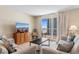 Cozy living room with comfortable seating and sliding glass doors leading to a balcony with ocean views at 9820 Queensway Blvd. # 804, Myrtle Beach, SC 29572