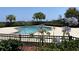 Outdoor pool with blue Agapanthus in foreground, featuring palm trees and a relaxing atmosphere for residents at 9820 Queensway Blvd. # 804, Myrtle Beach, SC 29572