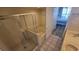 Well-lit bathroom includes a tiled shower, soaking tub, and a view of the bedroom at 102 N Ocean Blvd. # 405, North Myrtle Beach, SC 29582