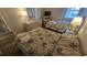 Cozy bedroom with wicker furniture, featuring two beds, dresser, and warm, inviting atmosphere at 102 N Ocean Blvd. # 405, North Myrtle Beach, SC 29582