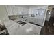 Updated kitchen featuring white cabinetry, marble countertops and stainless steel appliances at 102 N Ocean Blvd. # 405, North Myrtle Beach, SC 29582