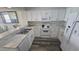 Modern kitchen featuring white cabinets, marble countertops, and stainless steel appliances at 102 N Ocean Blvd. # 405, North Myrtle Beach, SC 29582