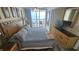 Bedroom with king bed, balcony access, ocean view, and a dresser with a TV at 102 N Ocean Blvd. # 405, North Myrtle Beach, SC 29582