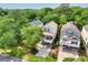 An aerial view of the neighborhood showcasing the home's landscaping and proximity to lush trees at 108 N Oak Dr., Surfside Beach, SC 29575