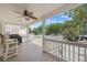 View of the outdoor back porch with furniture, ceiling fan, and railings at 108 N Oak Dr., Surfside Beach, SC 29575