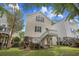 Back exterior of elevated home with deck and stairs to the yard at 108 N Oak Dr., Surfside Beach, SC 29575