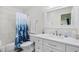 Modern bathroom features glass enclosed shower with blue tiled accent wall at 108 N Oak Dr., Surfside Beach, SC 29575