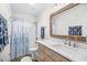 Bright bathroom featuring a vanity with framed mirror, a shower and tub combo at 108 N Oak Dr., Surfside Beach, SC 29575