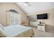 Bright bedroom features vaulted ceilings, fan, and a large window providing natural light at 108 N Oak Dr., Surfside Beach, SC 29575