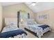 Charming bedroom with vaulted ceiling, fan, window, and two twin beds with decorative pillows at 108 N Oak Dr., Surfside Beach, SC 29575