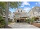Inviting beach house on stilts featuring a spacious covered deck and ground-level parking at 108 N Oak Dr., Surfside Beach, SC 29575