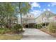 Exterior view of elevated home with front yard and driveway at 108 N Oak Dr., Surfside Beach, SC 29575