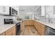 Modern kitchen with stainless steel appliances, hardwood floors, and stylish finishes at 108 N Oak Dr., Surfside Beach, SC 29575