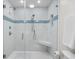 Modern shower with white tile, a blue accent wall, and glass door at 108 N Oak Dr., Surfside Beach, SC 29575