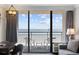 Comfortable seating on the balcony that provides stunning ocean views from this bright and airy condo living room at 1105 S Ocean Blvd. # 928, Myrtle Beach, SC 29577