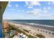 Overhead view of an expansive beach with ocean views, lounge chairs, and a swimming pool at 1105 S Ocean Blvd. # 928, Myrtle Beach, SC 29577