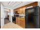 Functional kitchen featuring dark appliances, wooden cabinets, and an adjoining room with additional living space at 1105 S Ocean Blvd. # 928, Myrtle Beach, SC 29577