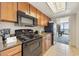 Well-equipped kitchen with black appliances, granite countertops, and ocean views at 1105 S Ocean Blvd. # 928, Myrtle Beach, SC 29577