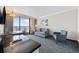 Comfortable living room with a sofa, accent chair, a kitchen bar and ocean views at 1105 S Ocean Blvd. # 928, Myrtle Beach, SC 29577