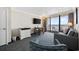 Cozy living room showcasing a comfortable sofa, dining table, television, and a balcony with ocean views at 1105 S Ocean Blvd. # 928, Myrtle Beach, SC 29577