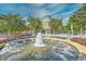 Beautiful water fountain surrounded by lush landscaping and benches in a charming community setting at 1141 Prescott Circle, Myrtle Beach, SC 29577