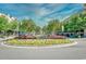 Beautiful circular fountain surrounded by colorful flowers and lush greenery in a charming neighborhood setting at 1141 Prescott Circle, Myrtle Beach, SC 29577