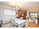 Open dining area with modern chandelier, hardwood floors, and adjoining kitchen with granite counters at 1141 Prescott Circle, Myrtle Beach, SC 29577