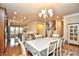 Open dining area with hardwood floors, modern chandelier, and stairs leading to the second floor at 1141 Prescott Circle, Myrtle Beach, SC 29577