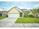 Charming yellow home featuring a two-car garage and well-manicured lawn at 1141 Prescott Circle, Myrtle Beach, SC 29577
