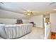 Bright, carpeted living room featuring a ceiling fan and neutral paint color with an open staircase to the lower level at 1141 Prescott Circle, Myrtle Beach, SC 29577