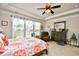 Bright main bedroom featuring large windows, tray ceiling, and comfortable sitting area at 1141 Prescott Circle, Myrtle Beach, SC 29577