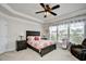 Spacious main bedroom with tray ceiling, large windows, and cozy seating area at 1141 Prescott Circle, Myrtle Beach, SC 29577