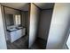 Double vanity in a bathroom, featuring white cabinets, dark countertops, and a private toilet and shower area at 1300 Rabbit Ln., Conway, SC 29526