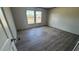 Bright bedroom with laminate flooring, two windows providing natural light, and neutral paint at 1300 Rabbit Ln., Conway, SC 29526