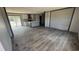 Spacious living room featuring an open floor plan, gray walls and laminate flooring, leading into the kitchen at 1300 Rabbit Ln., Conway, SC 29526
