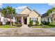 Charming yellow home featuring a well-manicured lawn and an inviting front porch at 1404 Riverport Dr., Conway, SC 29526