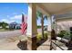 Inviting front porch view showcasing a patriotic American flag and cozy seating area at 1404 Riverport Dr., Conway, SC 29526
