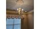 Bedroom featuring neutral walls, chandelier, and window with floral valance at 1426 Saint Thomas Circle # A 3, Myrtle Beach, SC 29577