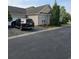 Exterior view of a brick home with a dark SUV parked in the driveway, showing the property's location at 1426 Saint Thomas Circle # A 3, Myrtle Beach, SC 29577