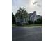 Charming home with a brick exterior, landscaped yard, and mature palm tree on a corner lot at 1426 Saint Thomas Circle # A 3, Myrtle Beach, SC 29577