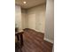 Hallway with multiple closets, dark wood floors, and neutral paint colors at 1426 Saint Thomas Circle # A 3, Myrtle Beach, SC 29577