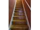 Staircase with wood steps and white risers, and a wooden handrail at 1426 Saint Thomas Circle # A 3, Myrtle Beach, SC 29577