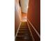 Staircase leading upstairs with a white railing, hardwood steps, and a striped accent wall at 1426 Saint Thomas Circle # A 3, Myrtle Beach, SC 29577