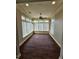 Bright sun room with lots of windows, white trim, and dark-wood flooring at 1426 Saint Thomas Circle # A 3, Myrtle Beach, SC 29577